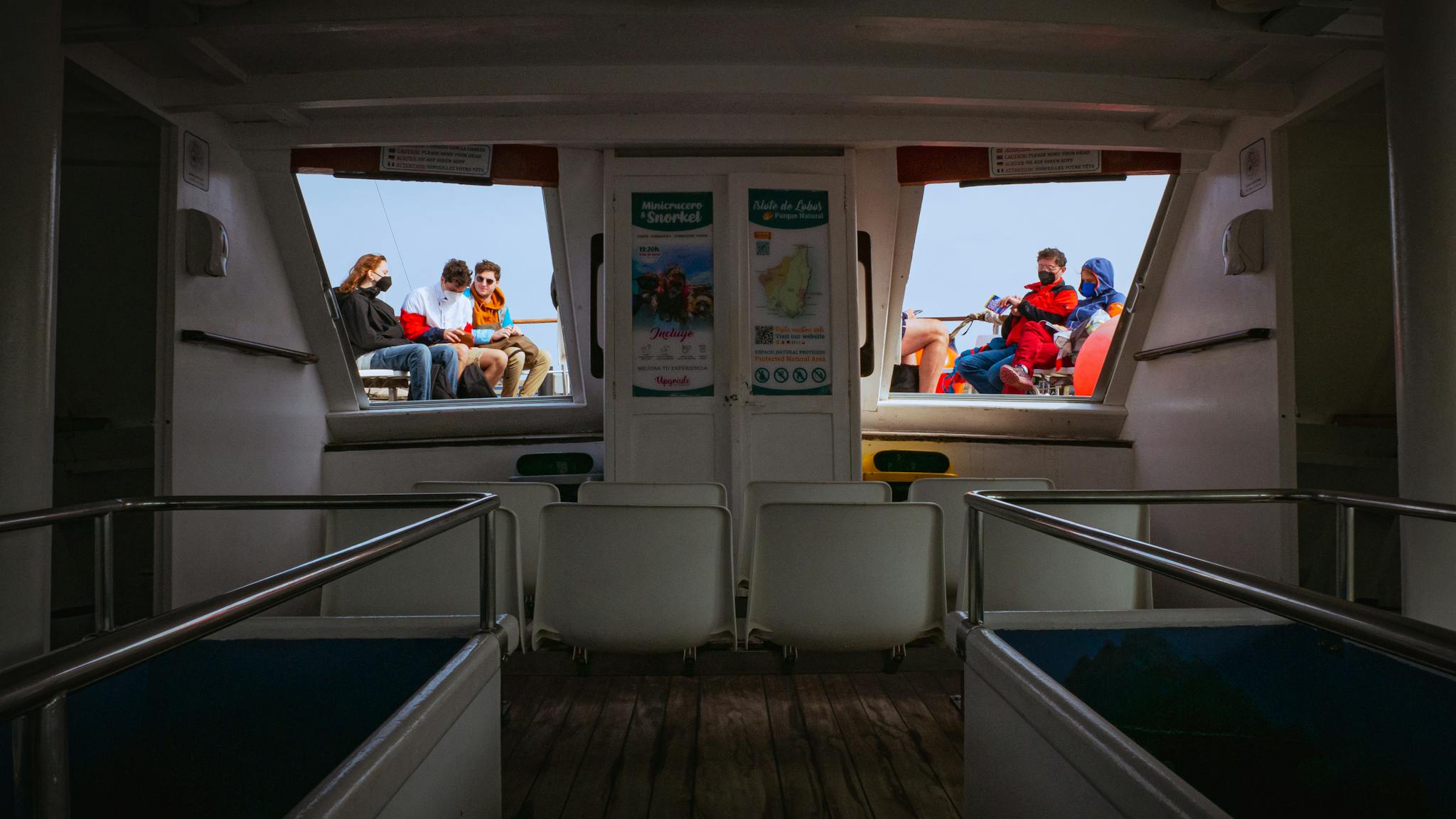 Passengers enjoying a scenic boat trip on a sunny day in Spain.